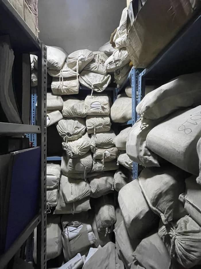 Bundled files in cloth sacks stacked floor to ceiling
